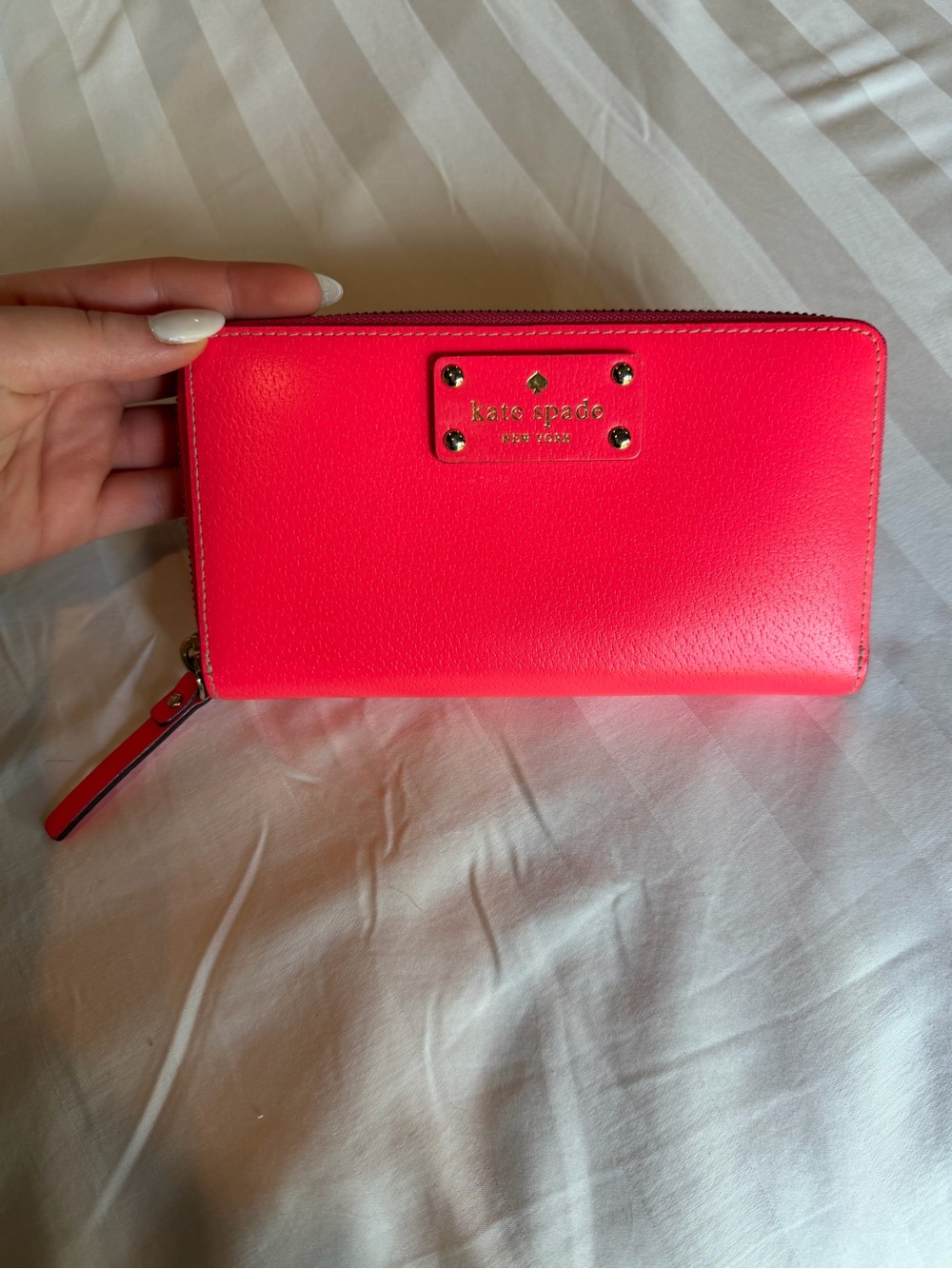 KATE SPADE neon pink zip-around leather wallet